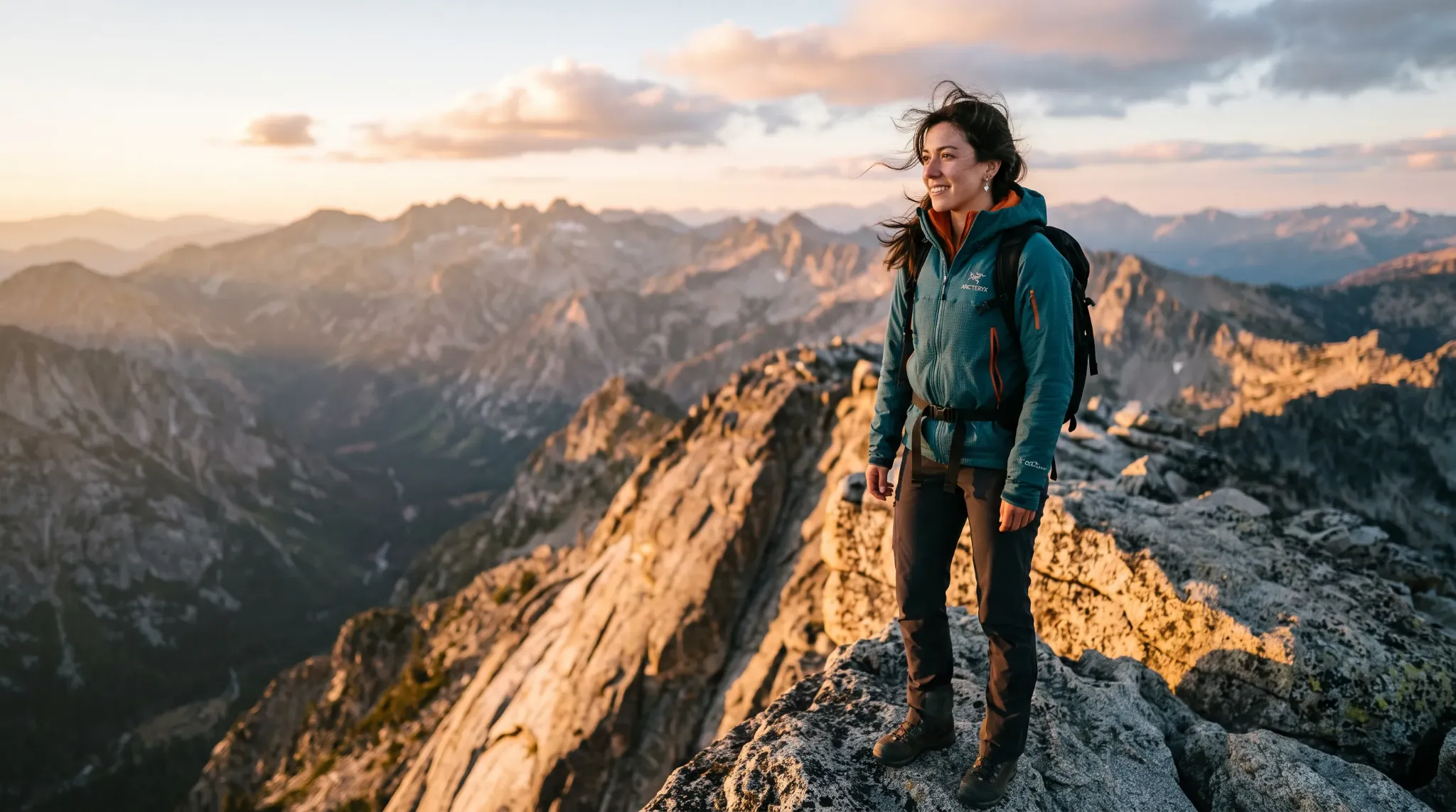 Alt text: Woman on a mountain summit.